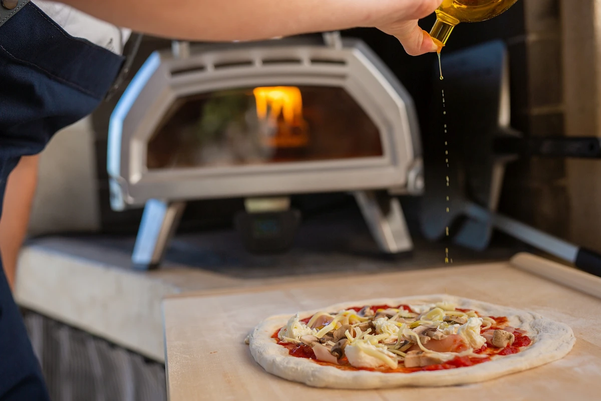 Olive oil goes on pizza